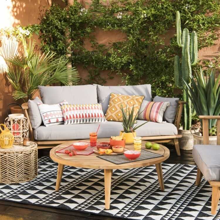balkon w miejskiej dżungli z drewnianymi meblami ogrodowymi